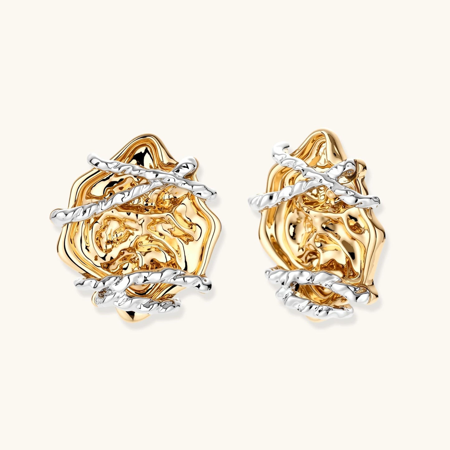 Sculptural rose-shaped stud earrings in gold with silver wire details and S925 posts on cream background.
