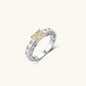 Adjustable ring with emerald-cut yellow zirconia center and clear accent stones in geometric platinum-plated setting